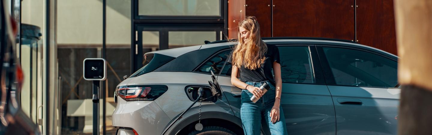 woman charging an electric car