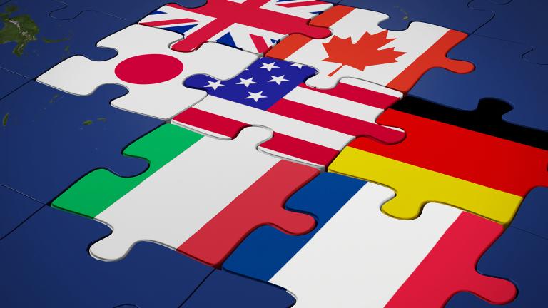 G7 nation flags interlocked as puzzle pieces