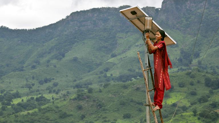 A solar engineer maintains the street lighting in her rural village of Tinginaput, India.