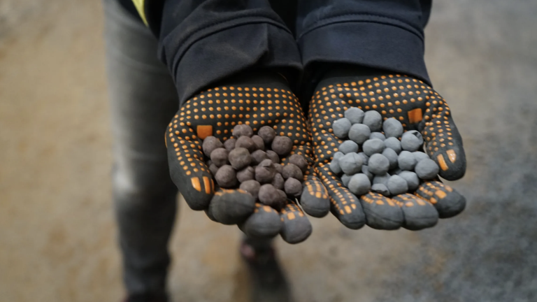 At HYBRIT's fossil-free steel plant in Luleå, Sweden, hydrogen made with renewable electricity turns reddish iron ore pellets, left, into grey pellets of sponge iron, which are ready to be melted down and made into steel.