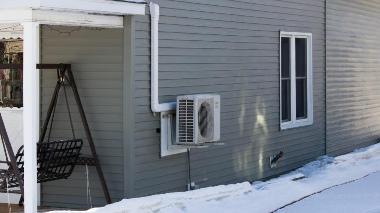 A heat pump is seen on the side of a home in Aroostook County, near Mars Hill.