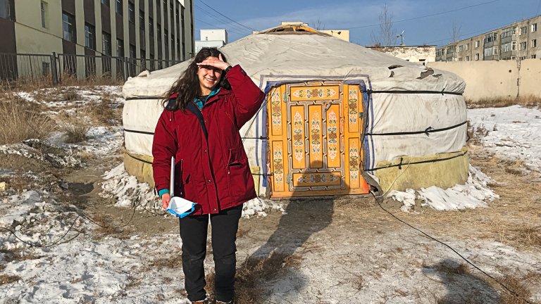 Iselle Barrios in Mongolia in front of a ger home.  