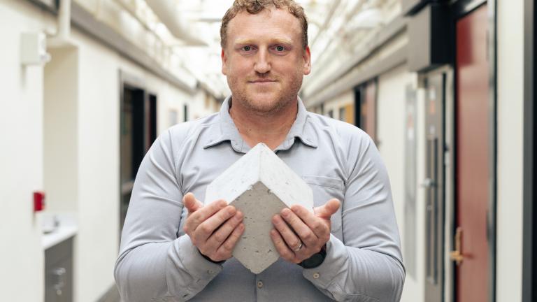 “Roman concrete to me is fascinating: It’s still standing after all this time and constantly repairing,” Admir Masic says, pictured here holding a Roman-inspired, self-healing concrete cube. 