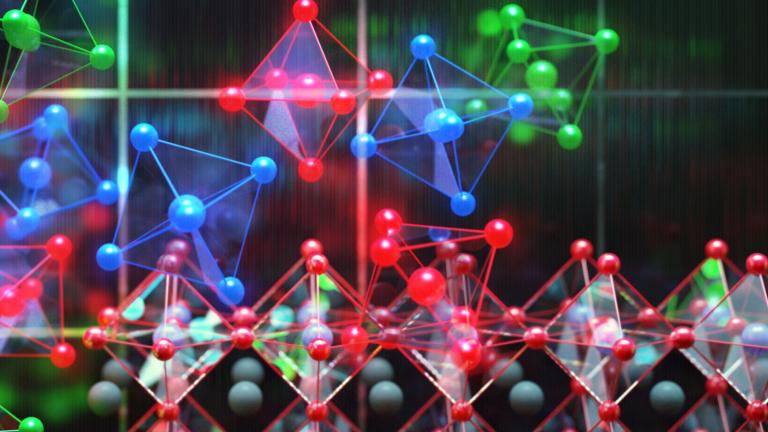 This image shows perovskite photovoltaics in the background with individual perovskite crystals shown as the colorful units. 