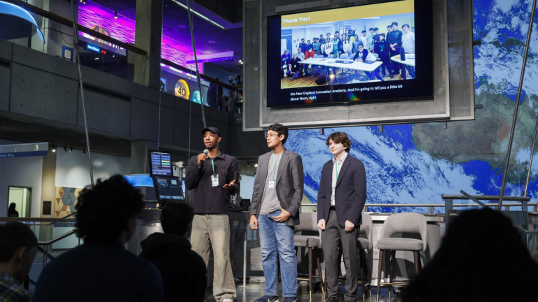 Langston Reid, Vishnu Bharath, and Simon Zall (left to right) discuss their project at the 2024 Day of AI global celebration at the Museum of Science. Day of AI is a free, hands-on curriculum developed by the MIT Responsible AI for Social Empowerment and Education (RAISE) initiative.