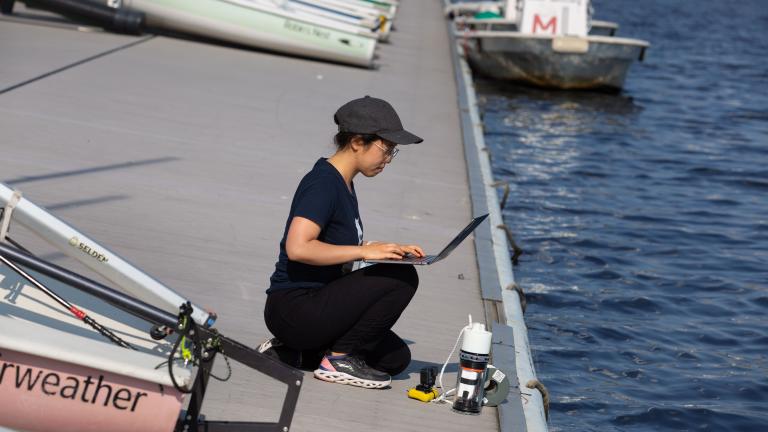 Charlene Xia, pictured at the MIT Sailing Pavilion, tests her microbiome monitoring system in the Charles River.