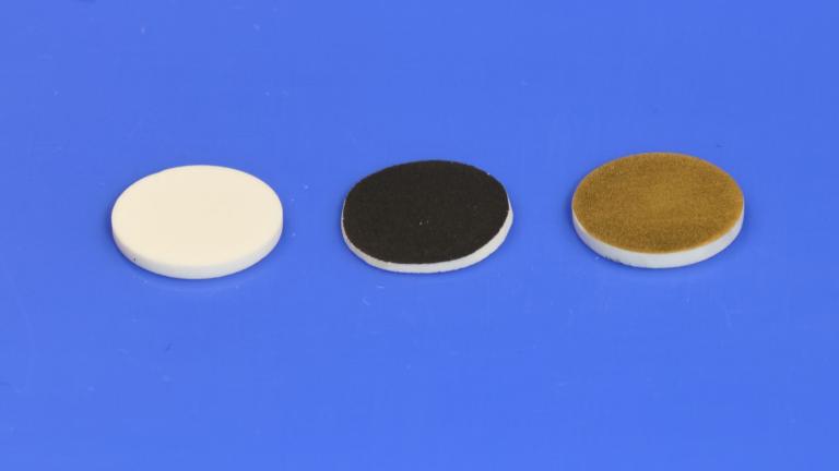 These discs were used for testing the researchers’ processing method for solid-electrolyte batteries. On the left, a sample of the solid electrolyte itself, a material known as LLPO. At center, the same material coated with the cathode material used in their tests. At right, the LLPO material with a coating of gold, used to facilitate measuring its electrical properties.