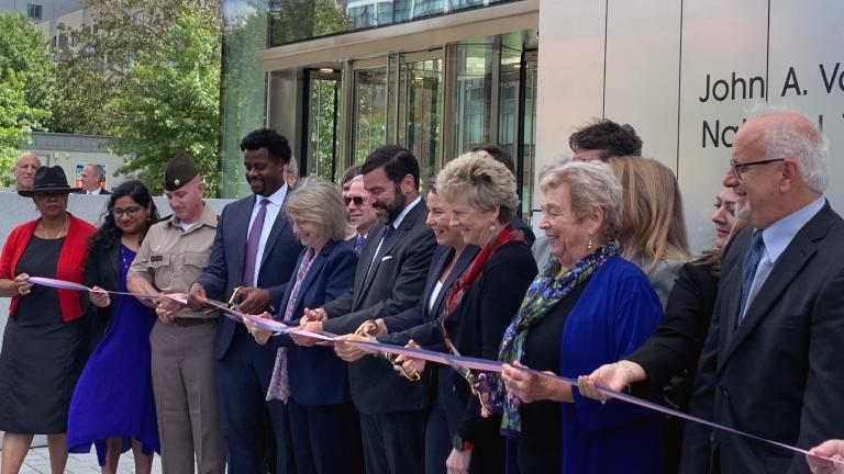 President Sally Kornbluth, fifth from left, joins Governor Maura Healey and members of the federal government and Cambridge community for a ribbon cutting at the new John A. Volpe National Transportation Systems Center.