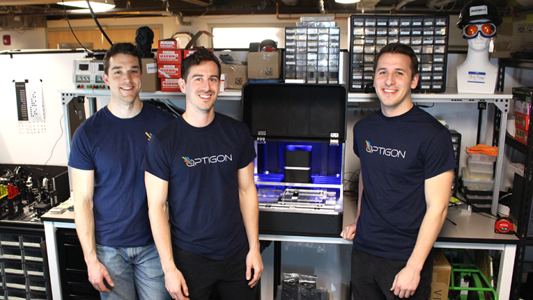 Optigon co-founders (from left to right) Brandon Motes, Dane deQuilettes, and Anthony Troupe stand with a benchtop version of the measurement tool they believe will help accelerate the pace of solar power and other clean energy products. 