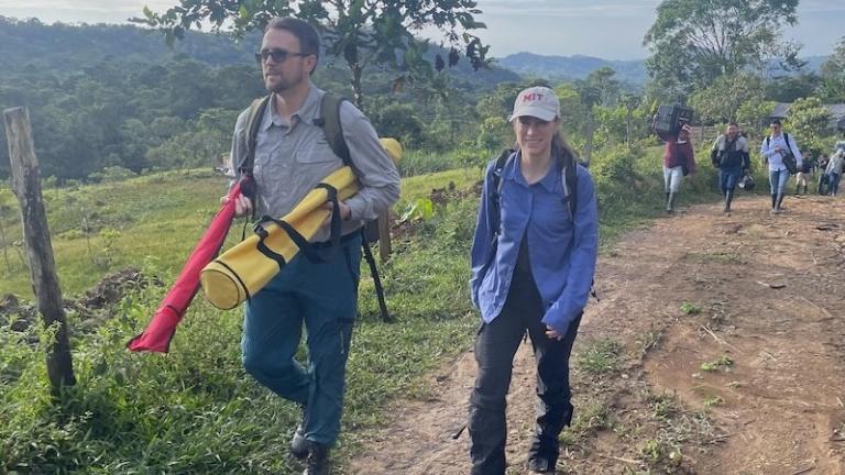 Sean Anklam (left), Marcela Angel, and a team from Corpoamazonia in the mountains outside Mocoa, Colombia, make their way to deploy an unpioloted aerial vehicle on a test flight.