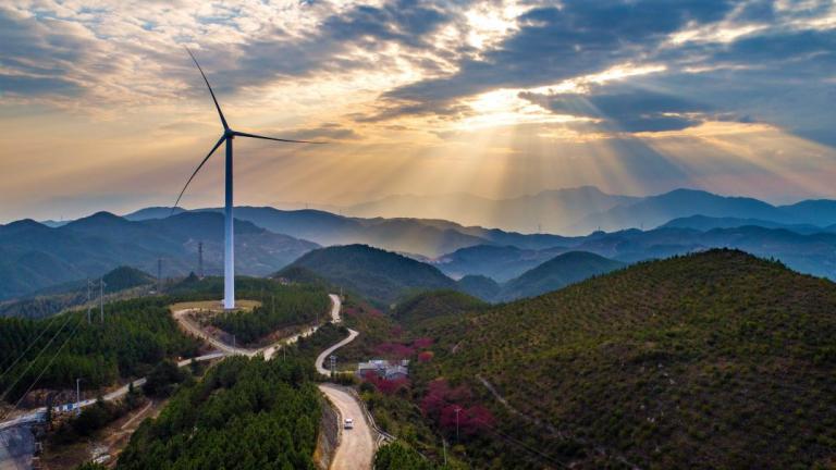 Wind turbine with sunset in background