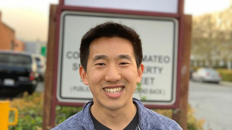 Joel Jean PhD ’17, co-founder of Swift Solar, stands in front of the company’s sign at its permanent location in San Carlos, California.