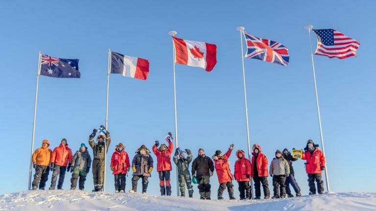 Scientists participating in Operation Ice Camp 2024 display flags representing their countries. 