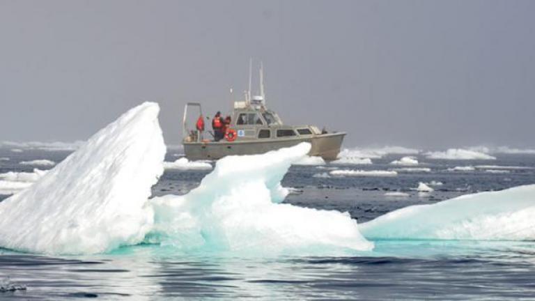 A research vessel and chunks of ice floating in the Arctic Ocean