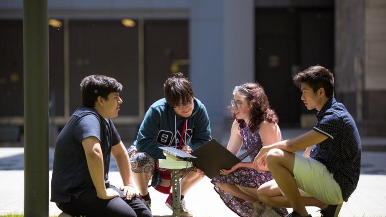 Left to right: Fabian Velasquez, Rafael Olivera-Cintron, Katherine Mohr, and Michael Lu test their solar-powered sensor in a sunny spot on the MIT campus. 