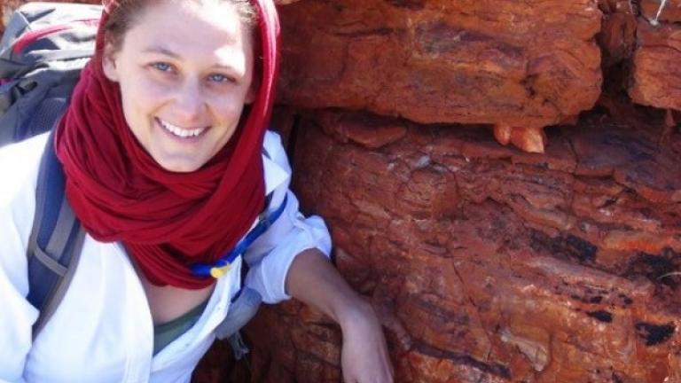 Tanja Bosak, who studies the processes by which rock formations were produced in ancient environments, stands in front of some of the oldest stromatolites in the Pilbara region of western Australia during an astrobiology tour in 2013. 