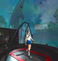 In the STRIVE Center, an immersive virtual reality facility overseen by the Biotechnology and Human Systems Division at Lincoln Laboratory, researchers collect data as a user tests a prototype ankle exoskeleton. 