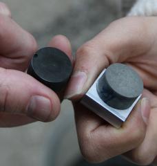 MIT CSHub postdocs Nicolas Chanut and Nancy Soliman hold two of their conductive cement samples. 