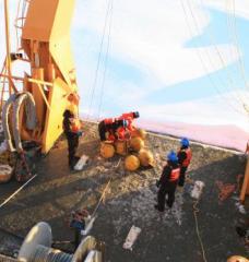 Scientists working on deck of research vessel