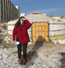 Iselle Barrios in Mongolia in front of a ger home.  