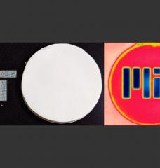 In the photo on the left, a disk of the new insulating material blocks and reflects visible light, hiding the MIT logo beneath it. But seen in infrared light, at right, the material is transparent and the logo is visible.