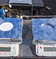 Two samples of passive cooling devices were tested on the roof of MIT's Building 1: On the left, a sample of the new system, combining evaporative cooling, radiative cooling, and insulation. On the right, a device using just evaporative cooling, for comparison testing.