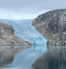 A glacier flows into a fjord in the southwest coast of Greenland.