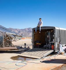 Jon Bessette sits atop a trailer housing the electrodialysis desalination system at the Brackish Groundwater National Desalination Research Facility (BGNDRF) in Alamogordo, New Mexico. The system is connected to real groundwater, water tanks, and solar panels. 