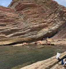 The composition and location of rock strata help scientists date when biomarkers were formed and deposited. Offshore in Zumaia, Basque Country (Spain), variations in the thickness and composition of sedimentary rocks show periodic changes in the Earth's orbit and tilt, affecting how much sunlight reaches Earth’s surface. This is near the Cretaceous-Paleogene boundary, associated with a mass extinction event.