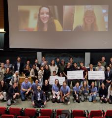 Energy and Climate Hack participants, in person and virtually, gather for a photo.