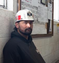 Dillion Grimmett, a coal miner who works at Gentry, sits in the mine’s main office entryway.