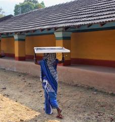 An Indian woman carries a solar panel developed by Khethworks, the first startup to emerge from the Tata Center. 