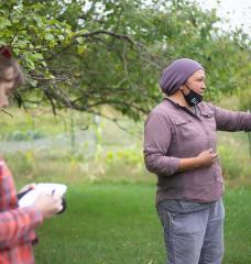 ESI Journalsim Fellow Nora Hertel (left) takes notes during a tour with Jessika Greendeer, seedkeeper and farm manager for Dream of Wild Health, a Native American-led nonprofit with a farm just outside the Twin Cities in Hugo, Minnesota.