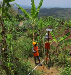 Officer checking the condition of the solar panel, early warning system, in anticipation of landslides