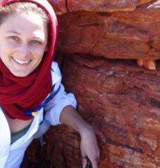 Tanja Bosak, who studies the processes by which rock formations were produced in ancient environments, stands in front of some of the oldest stromatolites in the Pilbara region of western Australia during an astrobiology tour in 2013. 