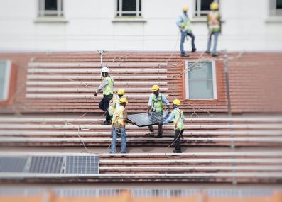 workers installing solar panels